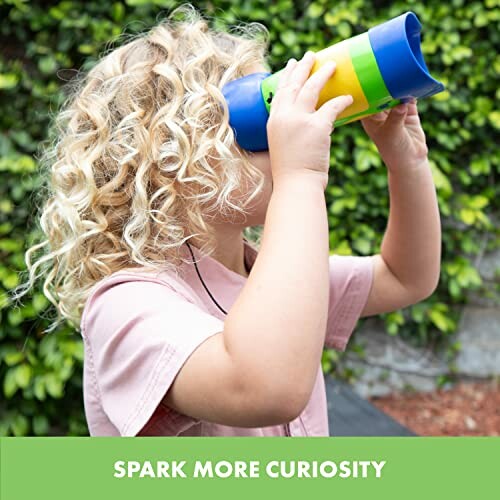 Child with curly hair looking through a colorful telescope outdoors.