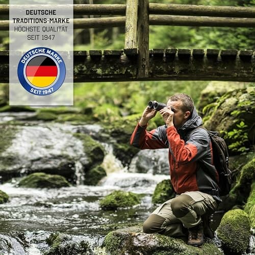 Hiker with binoculars by a stream in a forest