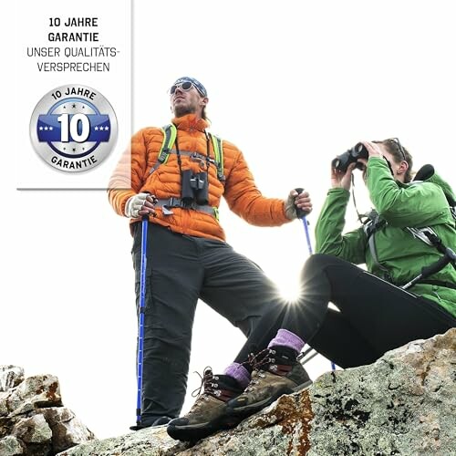 Two hikers on a rocky mountain, one standing with poles and the other using binoculars.